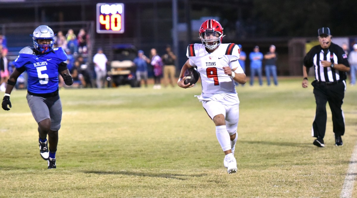 Midwest City Carl Albert quarterback Kevin Sperry runs for extra yardage during a recent game against Guthrie.